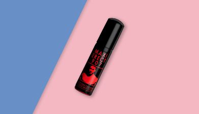 Schwarz-rotes Penis-Spray 'Maxi Erect 907' von Ruf auf rosa-blauem Hintegrund