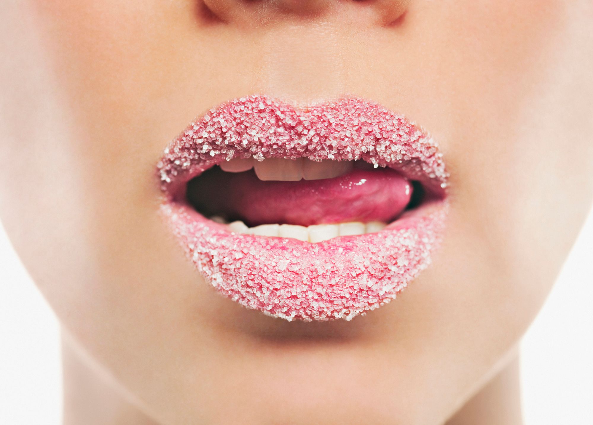 Frau mit Zucker auf den Lippen leckt sich die Lippen